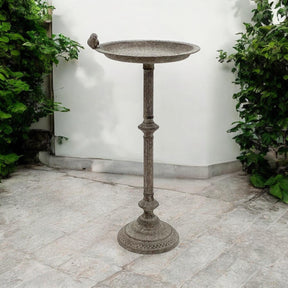 Antique iron birdbath and feeder