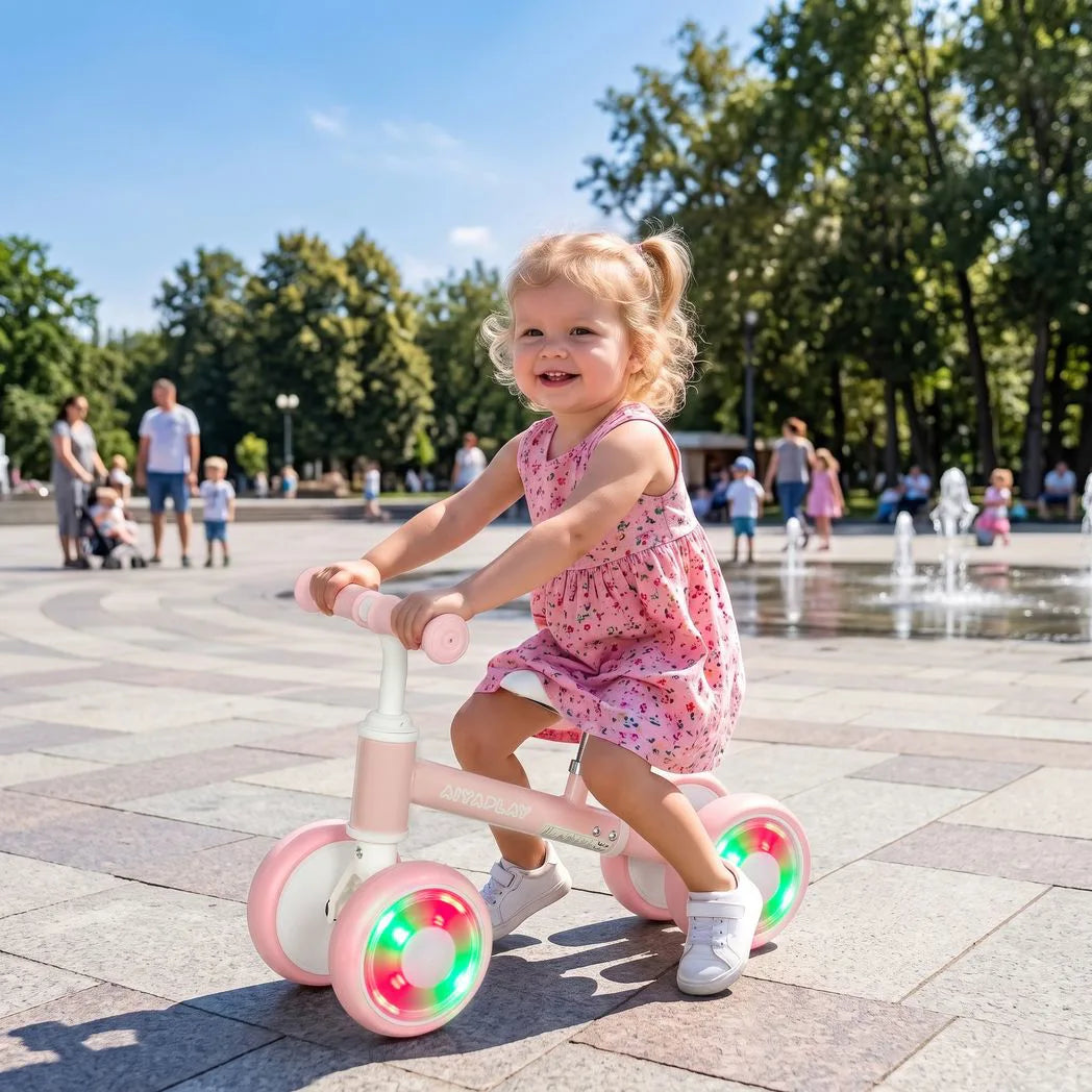 AIYAPLAY Baby Balance Bike for 1–2 Years with Four Light-up EVA Wheels and Adjustable Seat – Toddler Ride-On, Pink